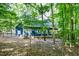 Rear view of a charming blue home with mature trees providing ample shade at 206 Lilliput Ln, Wake Forest, NC 27587