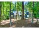 Front exterior of the charming blue home with lush landscaping and mature trees at 206 Lilliput Ln, Wake Forest, NC 27587