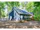 Charming blue home exterior with mature trees, fenced-in yard and private setting at 206 Lilliput Ln, Wake Forest, NC 27587
