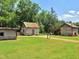 View of rustic log cabins amidst greenery and blue sky, evoking historical charm at 206 Lilliput Ln, Wake Forest, NC 27587
