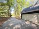 Driveway leading to attached garage of modern home surrounded by mature trees at 206 Lilliput Ln, Wake Forest, NC 27587