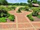 Brick pathway through a vibrant garden in E. Carroll Joyner Park, Wake Forest at 206 Lilliput Ln, Wake Forest, NC 27587