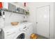 A laundry room featuring a washer, dryer, and wire shelving for storage at 206 Lilliput Ln, Wake Forest, NC 27587