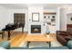 Bright living room with fireplace, piano, and hardwood floors at 206 Lilliput Ln, Wake Forest, NC 27587