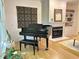 Elegant living room featuring a grand piano and fireplace with built-in shelving at 206 Lilliput Ln, Wake Forest, NC 27587