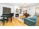 Inviting living room with a fireplace, a piano, and comfortable seating at 206 Lilliput Ln, Wake Forest, NC 27587