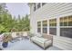 Cozy back deck showcases comfortable outdoor seating, and view of the wooded backyard at 210 Bennington Pkwy, Durham, NC 27713