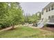 Landscaped backyard with multiple seating areas, a fire pit, and stone pathways at 210 Bennington Pkwy, Durham, NC 27713