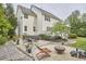 Spacious backyard featuring a hot tub, fire pit area, and a mix of stone and grassy areas at 210 Bennington Pkwy, Durham, NC 27713
