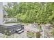 Serene backyard featuring a hot tub, stone patio with dining, hammock, and lush landscaping at 210 Bennington Pkwy, Durham, NC 27713