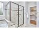 Bathroom featuring a glass-enclosed shower with built-in seating and tiled walls at 210 Bennington Pkwy, Durham, NC 27713