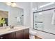 Bathroom boasts granite counters, dark wood cabinets, and tiled shower/tub combo at 210 Bennington Pkwy, Durham, NC 27713