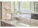 Bathroom vanity with granite countertop, and a view of the soaking tub at 210 Bennington Pkwy, Durham, NC 27713