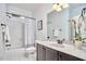 Bathroom with white tiled tub-shower and vanity with solid surface top at 210 Bennington Pkwy, Durham, NC 27713