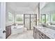 Bright bathroom with a soaking tub, walk-in shower, and granite countertops at 210 Bennington Pkwy, Durham, NC 27713