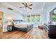 Main bedroom features beautiful windows, hard wood floors, a tray ceiling and a ceiling fan at 210 Bennington Pkwy, Durham, NC 27713