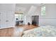 Bright bedroom features hardwood floors, a desk, and wainscoting detail at 210 Bennington Pkwy, Durham, NC 27713
