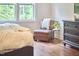 Cozy bedroom area featuring a chair, dresser, and natural light from the window at 210 Bennington Pkwy, Durham, NC 27713