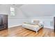 Bright bedroom features hardwood floors and wainscoting detail on the walls at 210 Bennington Pkwy, Durham, NC 27713