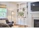 Living room featuring a fireplace, built-in shelving and a comfortable leather armchair at 210 Bennington Pkwy, Durham, NC 27713