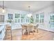Dining area featuring a round table, wicker chairs, wood floors, and bright natural light at 210 Bennington Pkwy, Durham, NC 27713