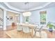 Well-lit dining room featuring decorative chandelier, natural light, and modern table with six chairs at 210 Bennington Pkwy, Durham, NC 27713