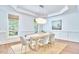 Bright dining room with large windows, stylish chandelier, and modern furnishings for elegant dining at 210 Bennington Pkwy, Durham, NC 27713