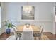 Elegant dining room featuring modern chandelier, wood table with six chairs, and neutral rug at 210 Bennington Pkwy, Durham, NC 27713