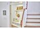 Bright entryway with a built-in bench, cubbies, shelf, wood floors, and stairway at 210 Bennington Pkwy, Durham, NC 27713