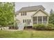 Rear exterior view highlighting the deck, screened porch, and lush backyard landscaping at 210 Bennington Pkwy, Durham, NC 27713