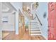 Bright foyer with wood floors and staircase, showcasing a grand entrance at 210 Bennington Pkwy, Durham, NC 27713