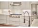 Bright kitchen with white cabinets, stainless steel appliances, and marble countertops at 210 Bennington Pkwy, Durham, NC 27713