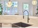 Modern kitchen with stainless steel faucet, farmhouse sink, and stylish pendant lighting at 210 Bennington Pkwy, Durham, NC 27713