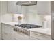 Gourmet kitchen featuring stainless steel range, white cabinetry, and sleek countertops at 210 Bennington Pkwy, Durham, NC 27713