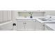 Well-lit laundry room boasts white cabinets and modern washer/dryer at 210 Bennington Pkwy, Durham, NC 27713