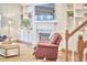 Living room featuring a fireplace, built-in shelving, hardwood floors, and a cozy leather armchair at 210 Bennington Pkwy, Durham, NC 27713