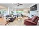 Living room with hardwood floors, fireplace, built-in shelves, ceiling fan, and comfortable seating at 210 Bennington Pkwy, Durham, NC 27713