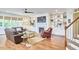 Spacious living room with a fireplace, built-in shelving, hardwood floors, and comfortable seating at 210 Bennington Pkwy, Durham, NC 27713