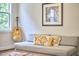 Sitting room with grey couch and a guitar at 210 Bennington Pkwy, Durham, NC 27713