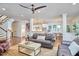 Open living room with hardwood floors, comfortable leather seating and access to the kitchen and dining area at 210 Bennington Pkwy, Durham, NC 27713