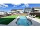 Fully fenced backyard with a refreshing in-ground pool, artificial turf and patio, perfect for outdoor gatherings at 232 Hensley Hill Pl, Holly Springs, NC 27540