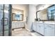 Elegant bathroom showcasing double vanities with white cabinets and framed mirrors at 232 Hensley Hill Pl, Holly Springs, NC 27540