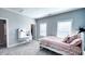 Bedroom featuring a cozy bed, study nook with white desk, and ample natural light at 232 Hensley Hill Pl, Holly Springs, NC 27540