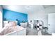 Bright bedroom featuring a blue accent wall, white furniture and ample storage at 232 Hensley Hill Pl, Holly Springs, NC 27540