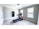 Bright exercise room with treadmill, neutral walls, and carpet, great for a home gym setup at 232 Hensley Hill Pl, Holly Springs, NC 27540