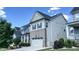 Beautifully constructed home with a brick and siding facade, complemented by well-maintained landscaping and a driveway at 232 Hensley Hill Pl, Holly Springs, NC 27540