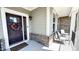 Inviting front porch with comfortable seating, stylish decor, and an elegant entrance door with sidelights at 232 Hensley Hill Pl, Holly Springs, NC 27540
