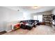 Upstairs living room featuring a large sectional sofa, stylish shelving, and cozy decor at 232 Hensley Hill Pl, Holly Springs, NC 27540