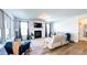 Cozy living room with a fireplace, ample seating, large windows, hardwood floors and natural light at 232 Hensley Hill Pl, Holly Springs, NC 27540