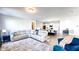 Open-concept living area flows to the kitchen, creating a spacious and comfortable area for relaxing and entertaining at 232 Hensley Hill Pl, Holly Springs, NC 27540